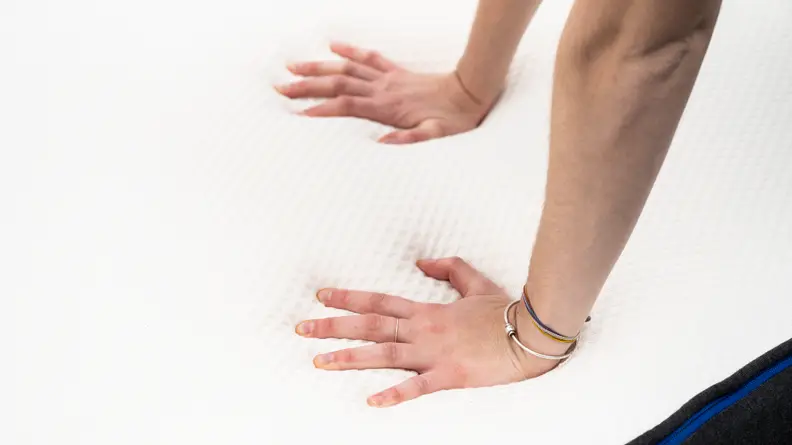 hands pushing onto Nectar mattress