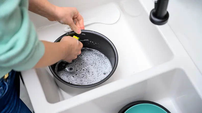 Rinse the rice cooker inner pan under water after it cools.