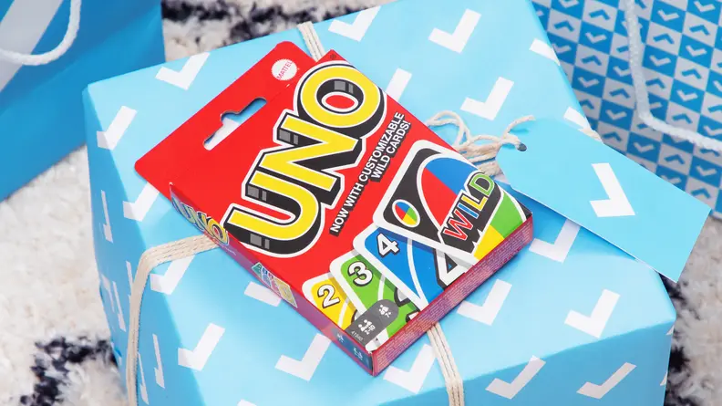 A box of Uno cards on a Reviewed gift box.