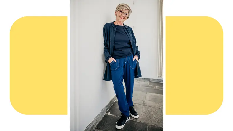 A person wearing jeans and a soft-looking gray top from Sam, Sensory & More