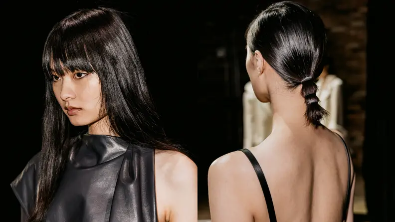 Portrait of a woman with pin-straight hair and a wound-up ponytail.