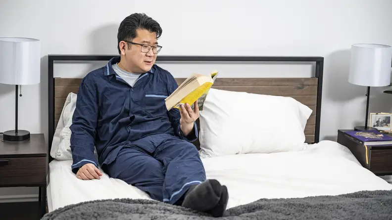 Man wearing blue David Archy pajamas set.