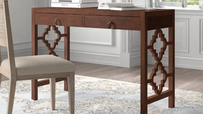 A grey chair and brown home office desk.