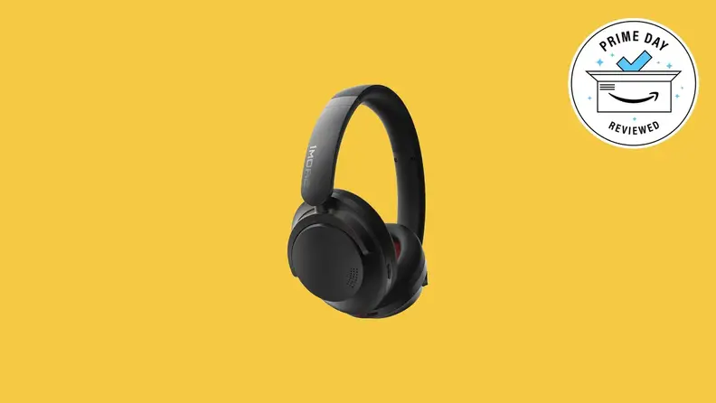 A pair of black wireless headphones on a colored background