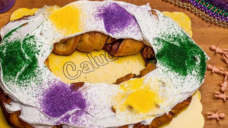 A photo of Claudia's King Cake with festive sprinkles, shot from above.