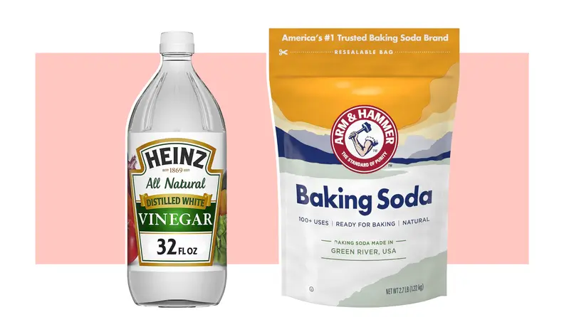 A bottle of Heinz vinegar and a packet of Arm & Hammer baking soda.