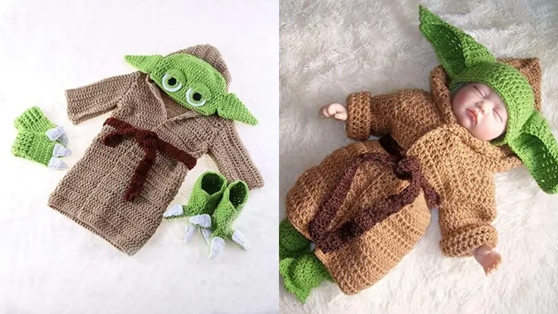 An infant dressed in a Baby Yoda costume.