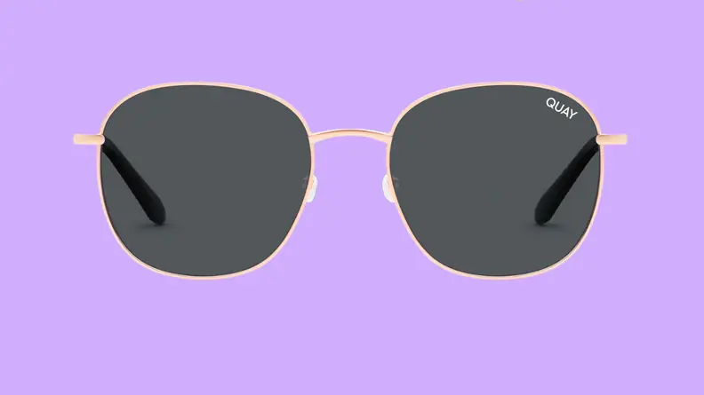 An image of a pair of round, gold-framed sunglasses.