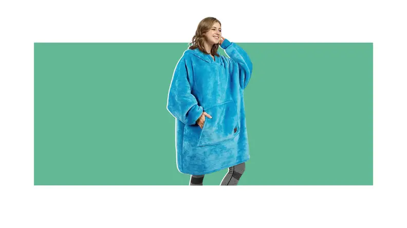 Person posing with arm behind head while wearing blue weighted blanket hoodie.
