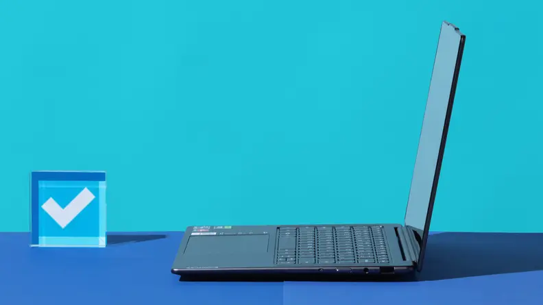 Viewing an open laptop from the side against a blue background