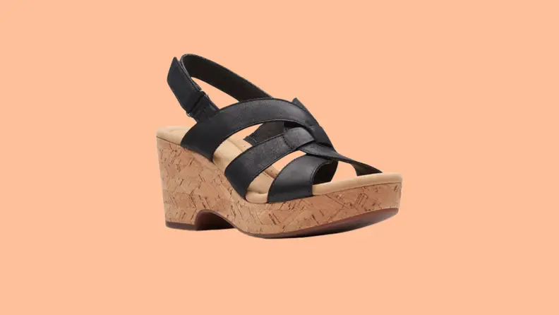 A high wedge sandal with black leather straps.