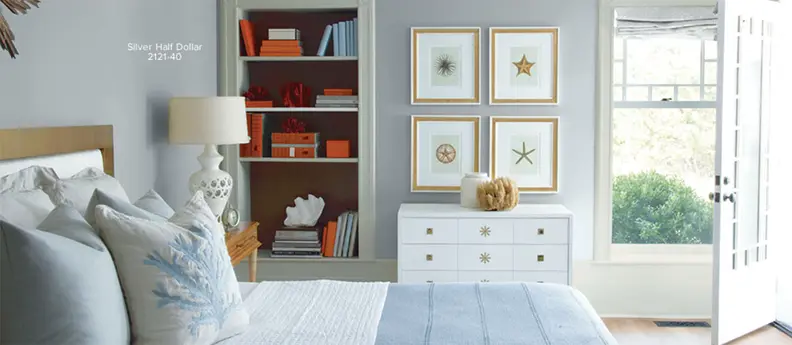 A silvery wall color enhances this bedroom