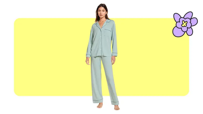Model showcasing a set of Eberjey pajamas in Surf Spray/Agave color in front of a yellow background with a purple cartoon flower.