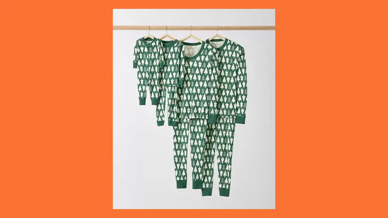 Hanna Andersson tree pajamas on an orange background.