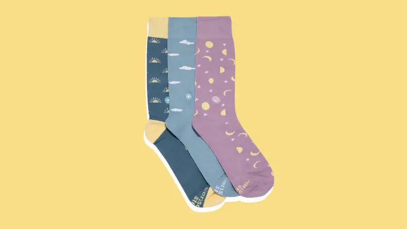 Three patterned socks on a yellow background.