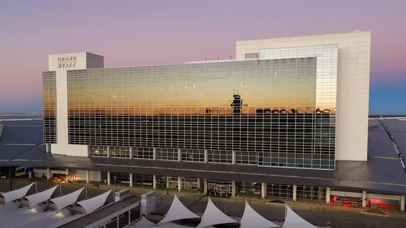 View of Grand Hyatt DFW reflecting the sunset at the airport