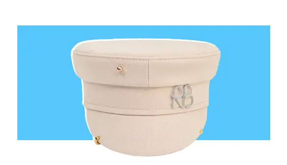 A cream-colored hat with gold piercings.
