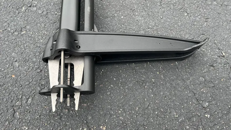 The four metal claws of the weeding tool.