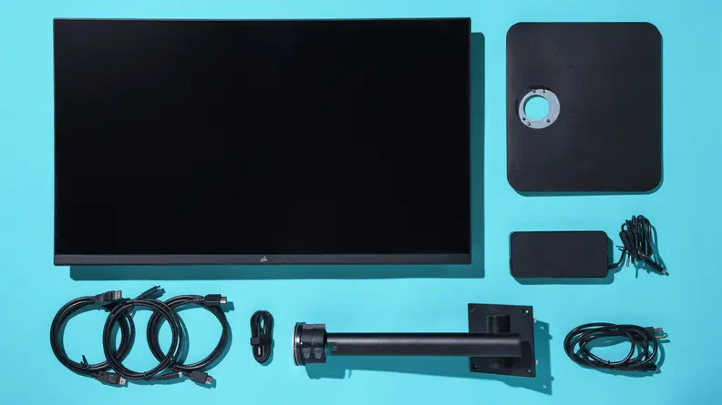 The monitor disassembled with all of its individual pieces laying flat on a surface.