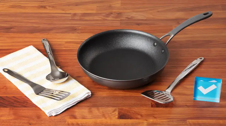 Metal utensils on a white napkin, next to the Circulon ScratchDefense cookware.