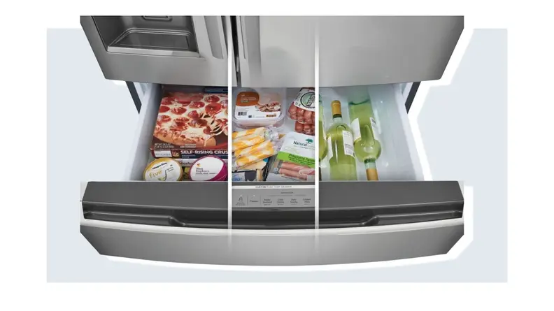 Three sections within the Custom-Flex Temp drawer filled with frozen foods, assorted deli meats and cheeses and bottles of wine from left to right on the Frigidaire Gallery GRMC2273CF refrigerator.