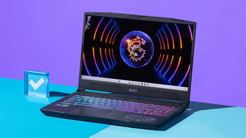 An open and powered on black laptop with a neon-lit keyboard against a purple and blue backdrop.