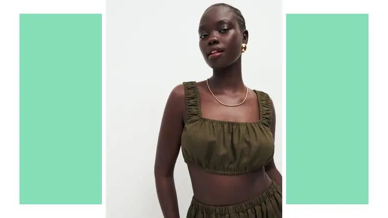 A model wears a green crop top with wide straps.