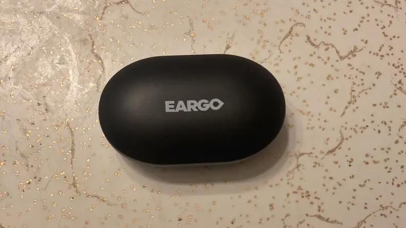Link by Eargo charging case on a countertop.