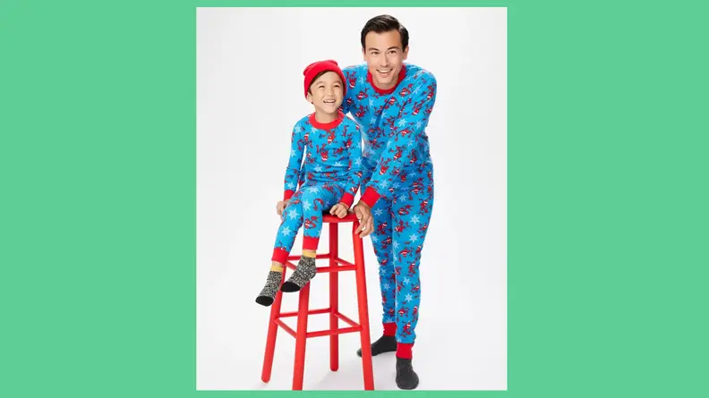 A father and son wearing the Hanna Andersson Spider-Man holiday matching family pajamas.