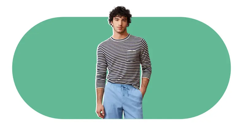 A male model wearing a cashmere T-shirt with horizontal black and white stripes.