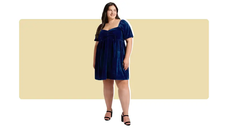A model wearing a knee-length blue velvet dress.