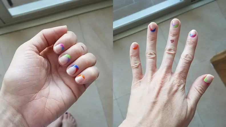 On the left and right: The author's hand wearing the Es-cape Verde set of gel nails from ManiMe and flexing her hand.