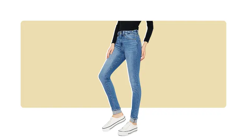 A model seen from the waist down, wearing blue skinny jeans.