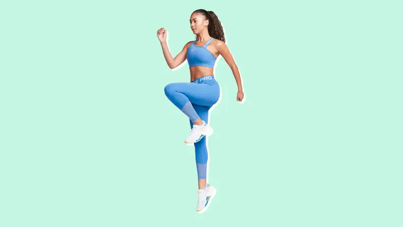A woman doing leg lifts in blue Nike Pro Leggings.