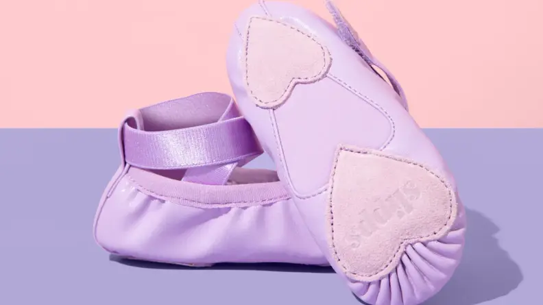 Purple Slipps ballet slippers on a pink background