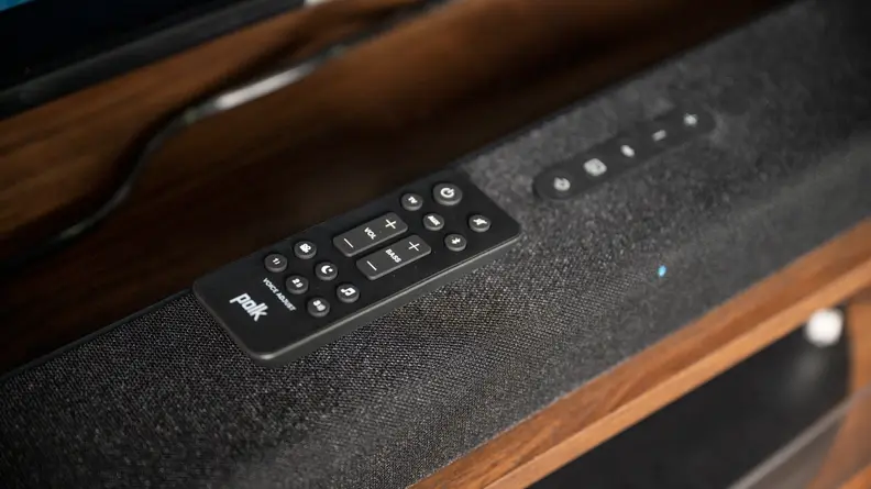 The Signa S4 remote sitting on top of the soundbar