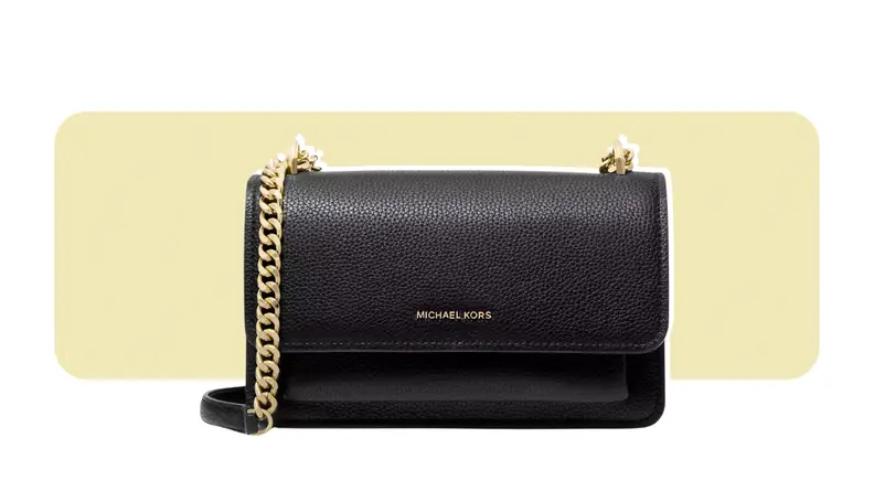 A pebble-leather purse that has a flap closure and a chain strap.