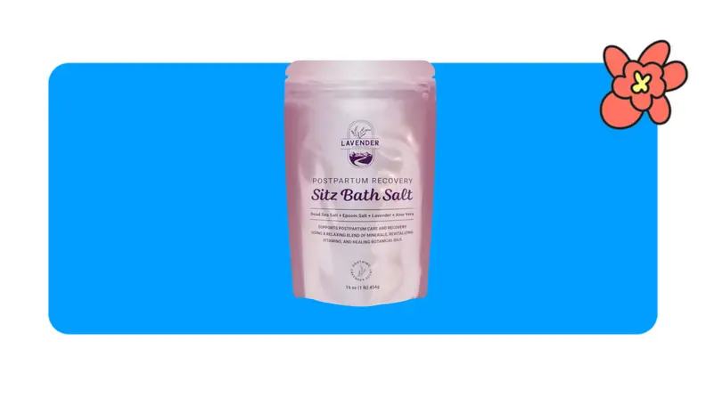 A single pink metallic bag filled with Lavender Sitz Bath salts in front of a blue background with a red cartoon flower in the corner.