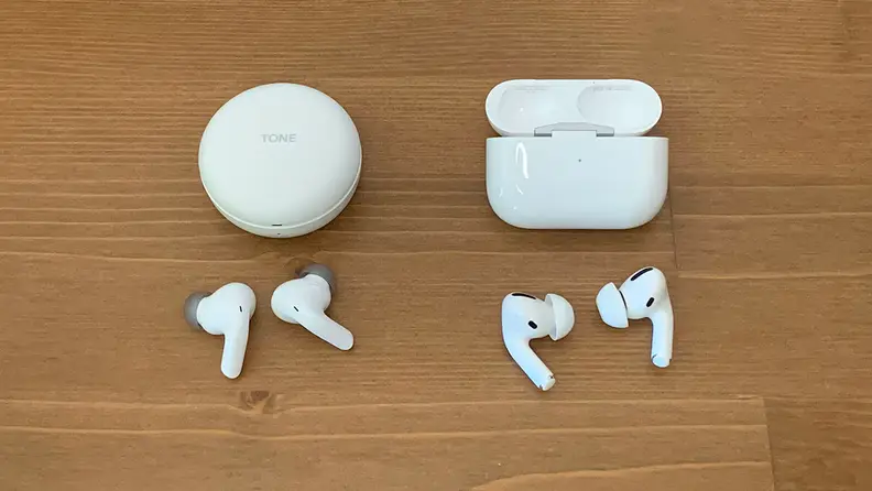The LG T90Q and Apple AirPods Pro sit on a wooden table below their cases.