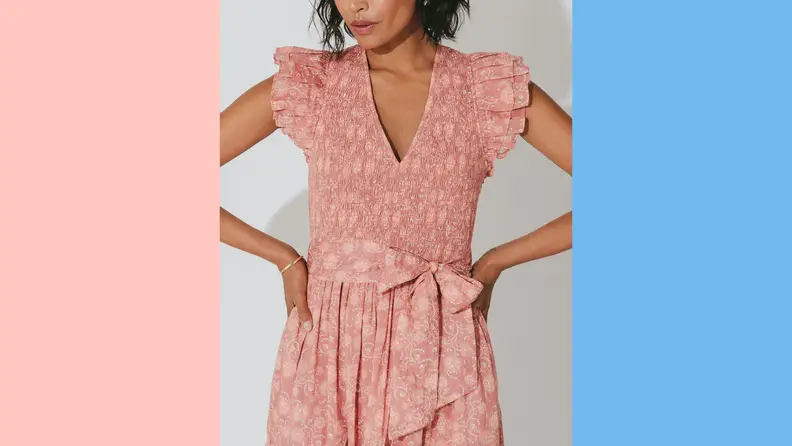 A woman posing in a floral dress by Cleobella.