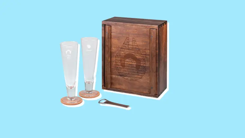 A set of pilsner glasses on cork coasters with a bottle opener, and a wooden box with an etching of the Millennium Falcon.
