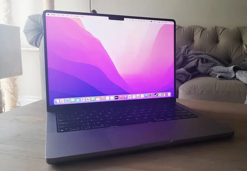 The MacBook Pro 14 lies on the table, open and on.