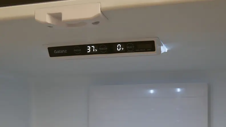 A close-up of the fridge's control panel  where the digital temperature readout states that the fridge is currently at 37°F and its freezer is 0°F.