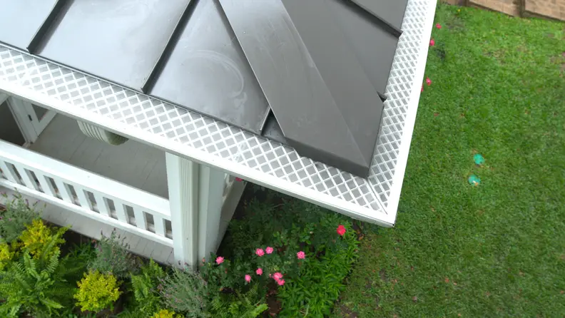 Close-up of roof edge with LeafFilter-style micro-mesh gutter guard covering the gutter.
