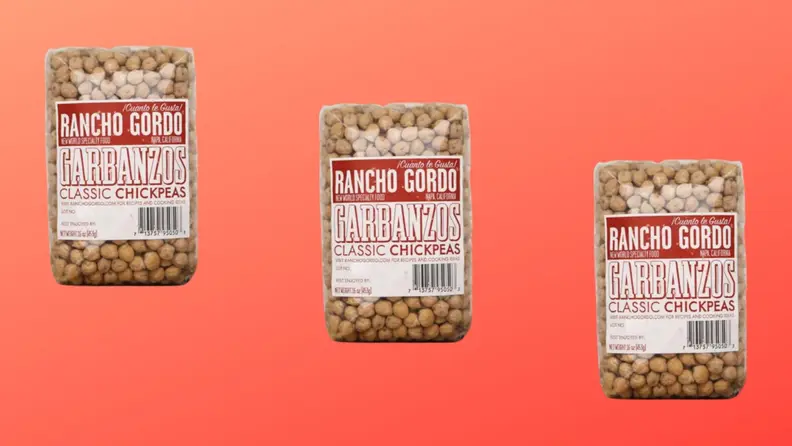 Three packages of garbanzo beans arranged in a diagonal row on a red background.