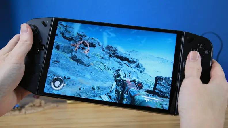 A pair of hands playing with the Lenovo Legion Go while Starfield is being displayed.