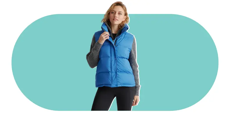 A model wearing a blue puffer vest.