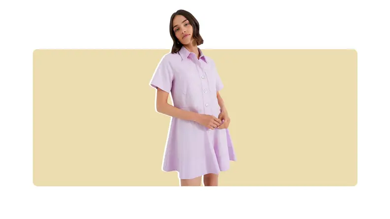 A lilac mini shirt dress with short sleeves.
