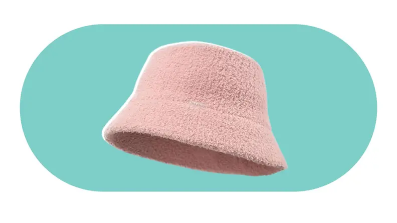 A model wearing a fuzzy pink bucket hat.