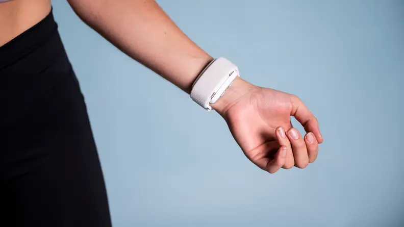 A person wears the Apollo Neuro on the inside of their wrist.